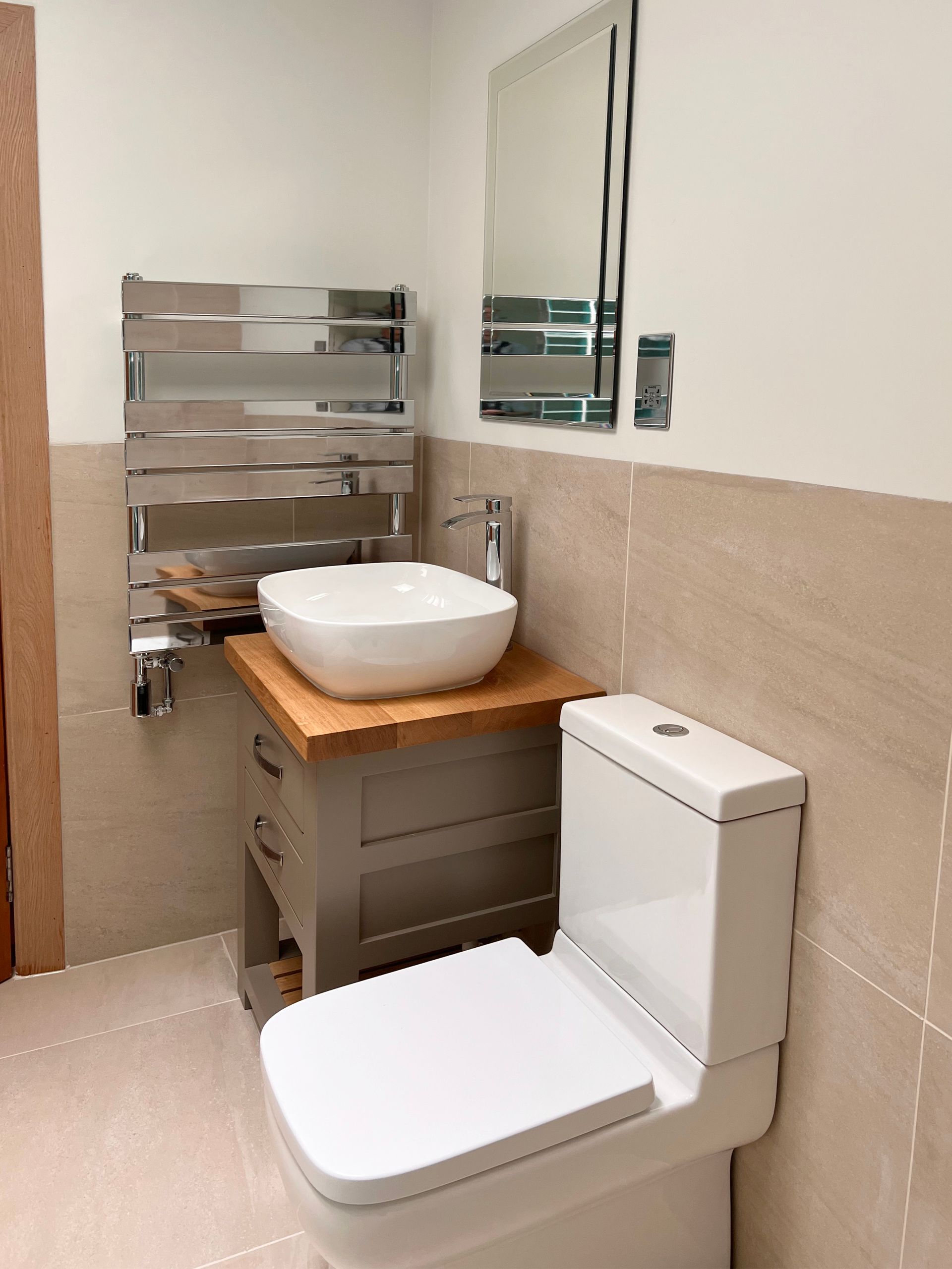 A bathroom with a toilet , sink and mirror