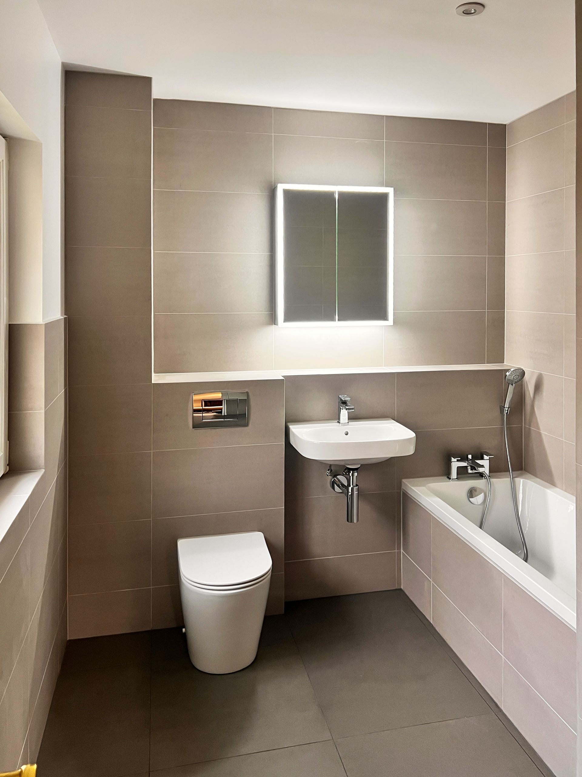 A bathroom with a toilet a sink and a bathtub