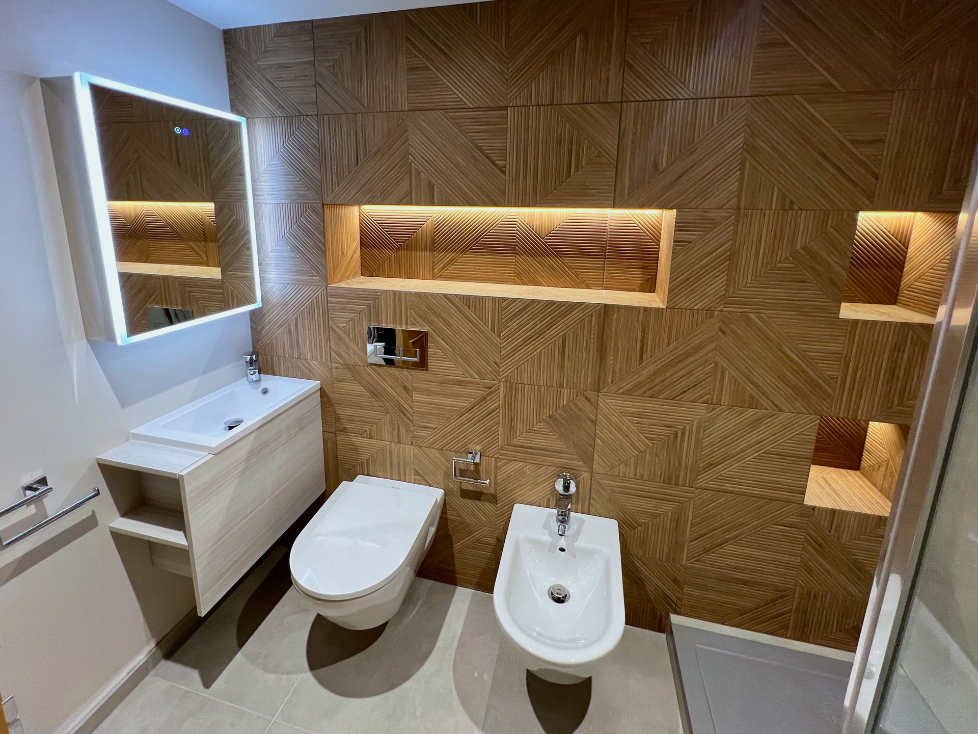 A completely re-designed wet room with sink, toilette, bidet and a walk-in shower.