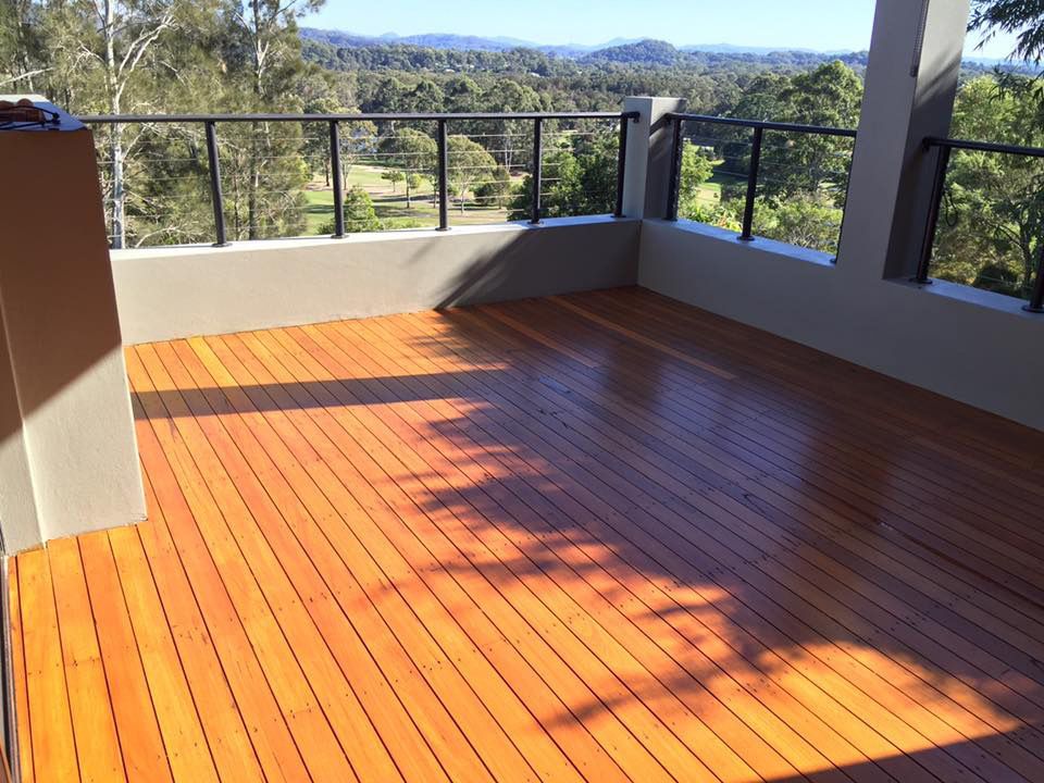 A Wooden Deck With A View Of Trees And Mountains — Byron Floor Sanding In Norther Rivers, NSW