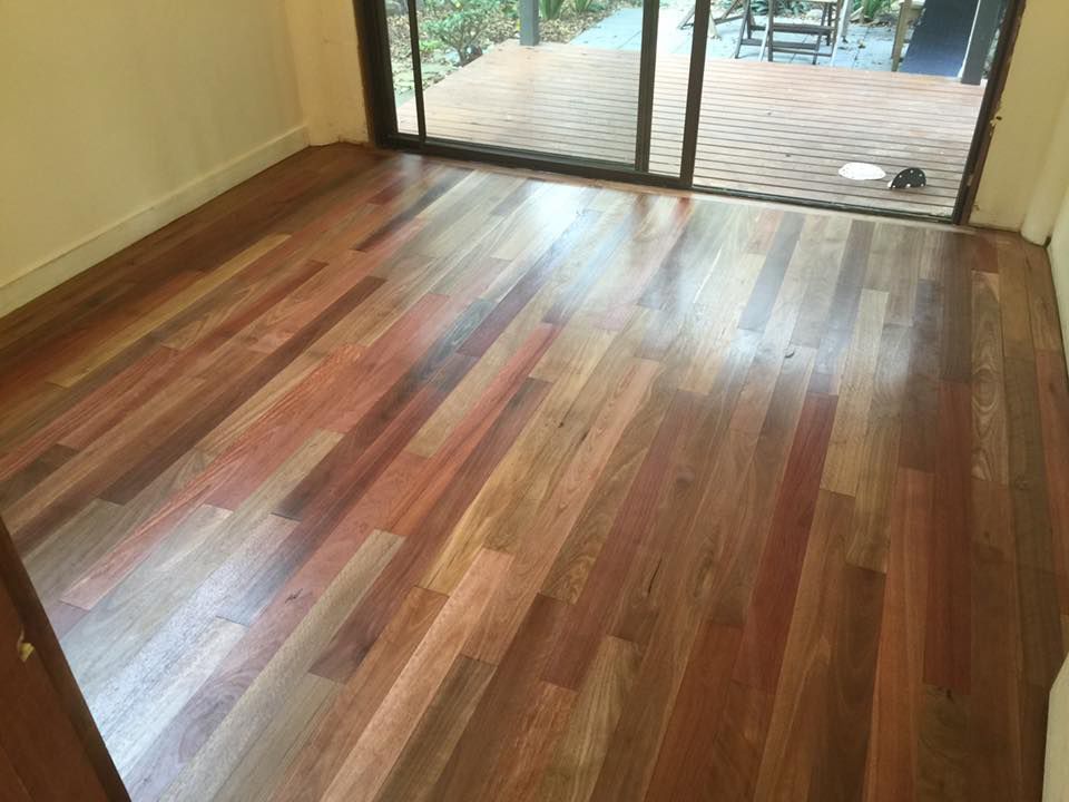 A Room With A Wooden Floor And A Sliding Glass Door — Byron Floor Sanding In Yamba, NSW