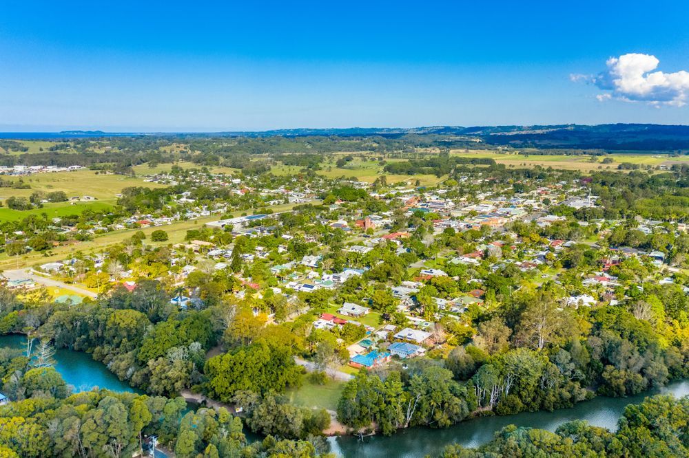 Aerial View of A Town Surrounded by Green Trees and a Blue River — Byron Floor Sanding In Mullumbimby, NSW