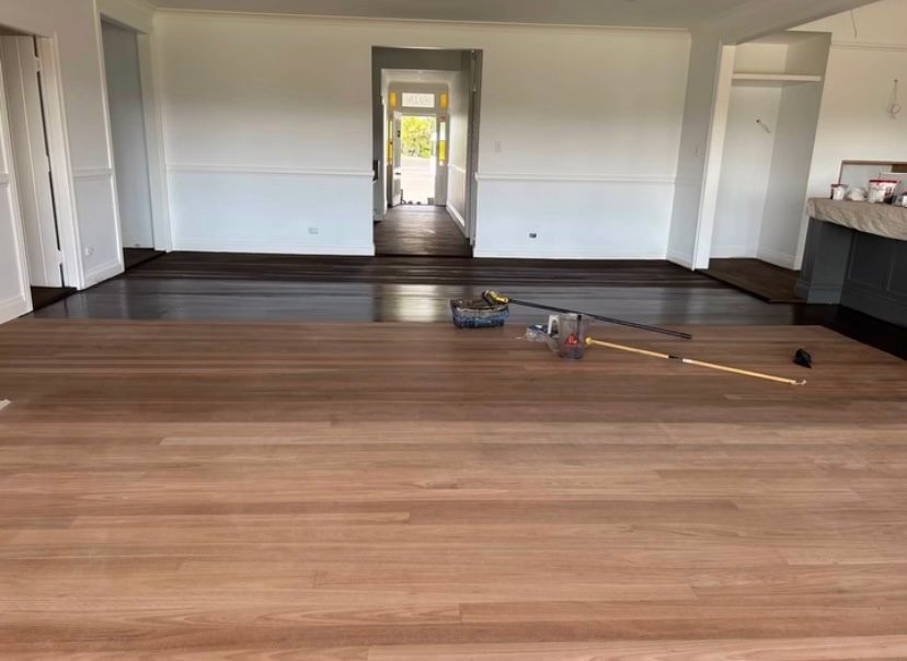 A Room With Wooden Floor Boards in the Process Of Being Polished — Byron Floor Sanding In Tintenbar, NSW