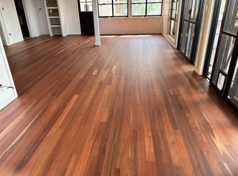 A Room With A Polished Wooden Floor and Windows and a Pole — Byron Floor Sanding In Alstonville, NSW