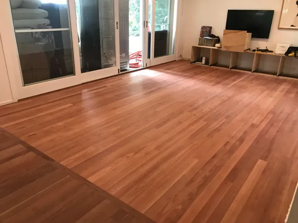 A Room With Sliding Doors and Wooden Floors— Byron Floor Sanding In Casino, NSW
