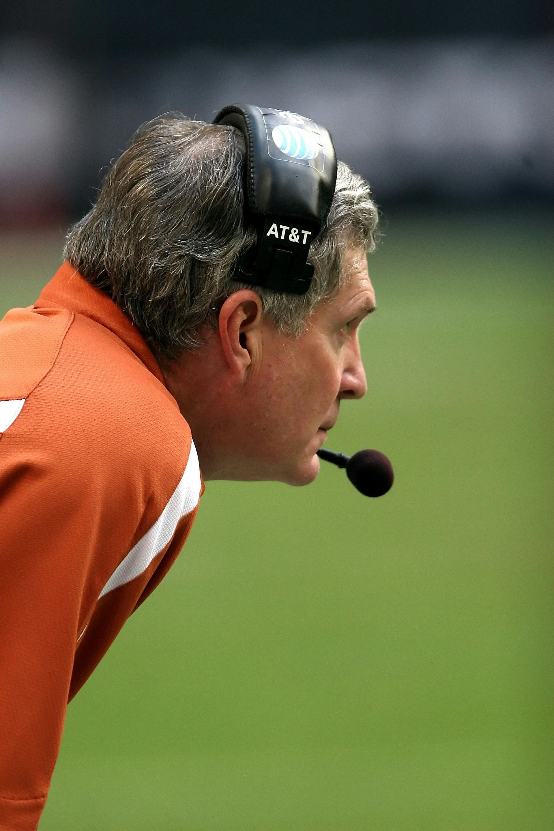 A man wearing a headset that says at & t on it