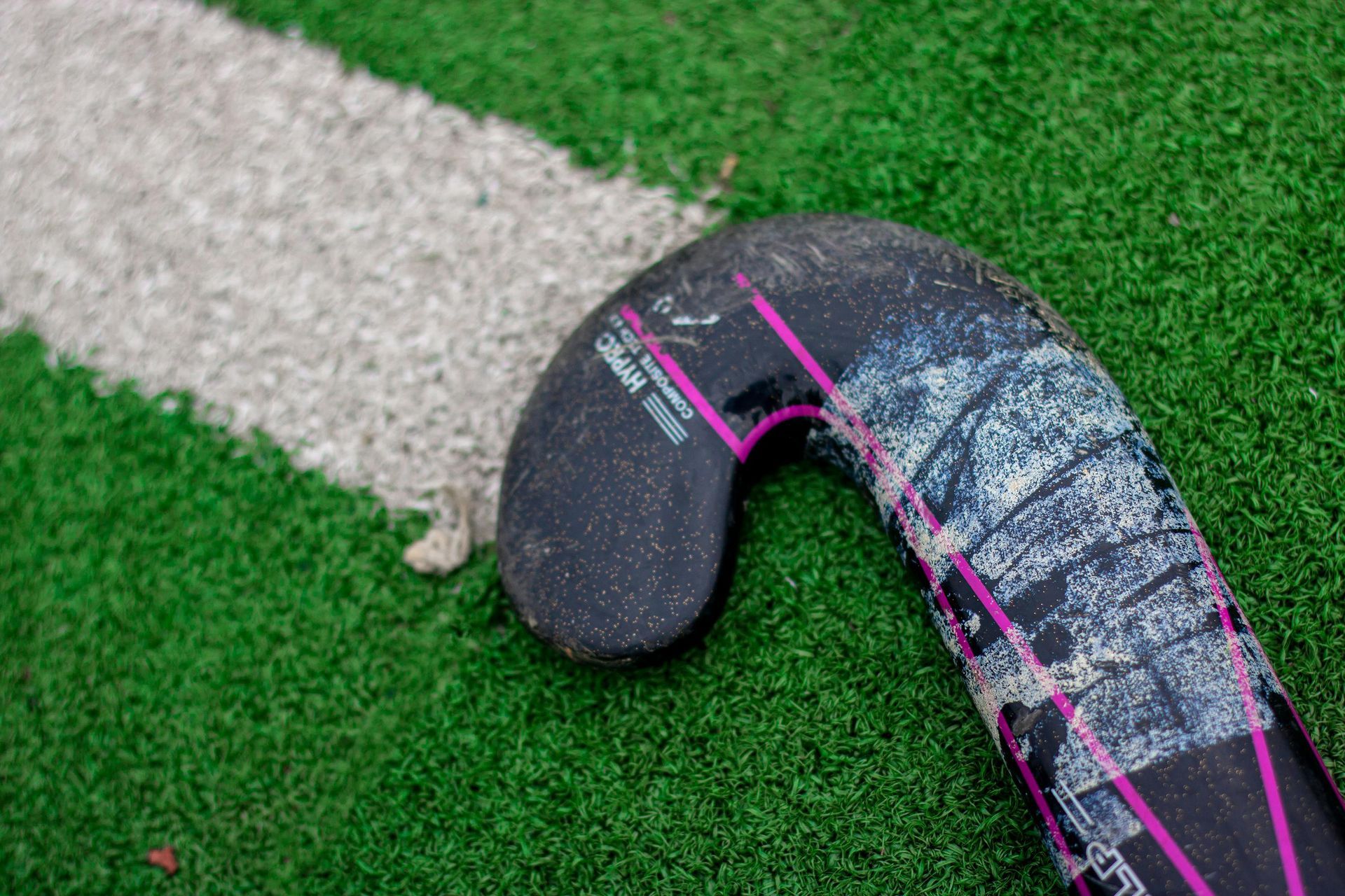 A close up of a hockey stick on a field.