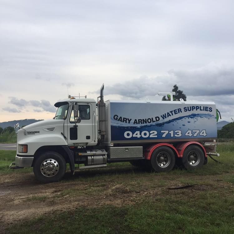 A Gary Arnold Water Supplies Truck Is Parked In A Grassy Field — Gary Arnold Water Supplies in Uki, NSW