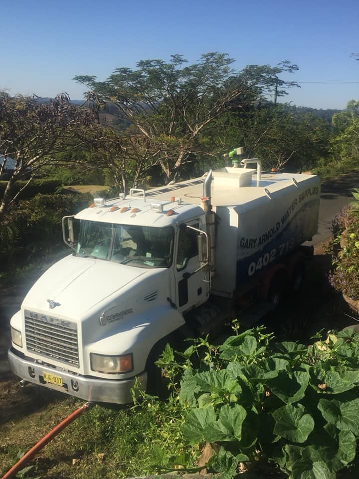 A White Truck Is Parked On The Side Of The Road — Gary Arnold Water Supplies in Uki, NSW