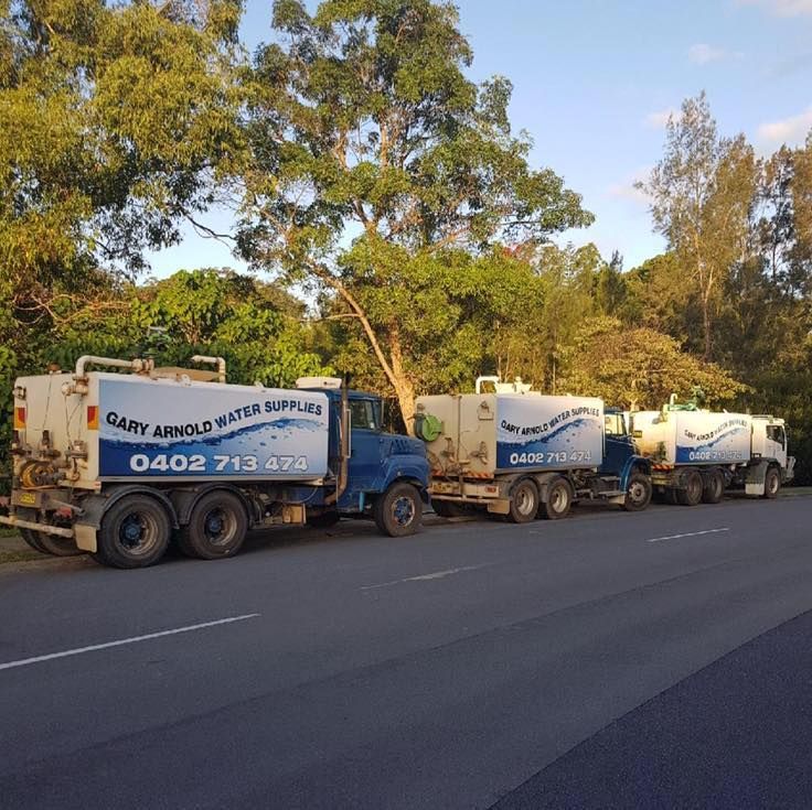 3 Water trucks lined up on a road — Gary Arnold Water Supplies in Uki, NSW