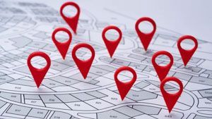 Red map pins placed across various sections of a gray-toned neighborhood plot plan or land survey.