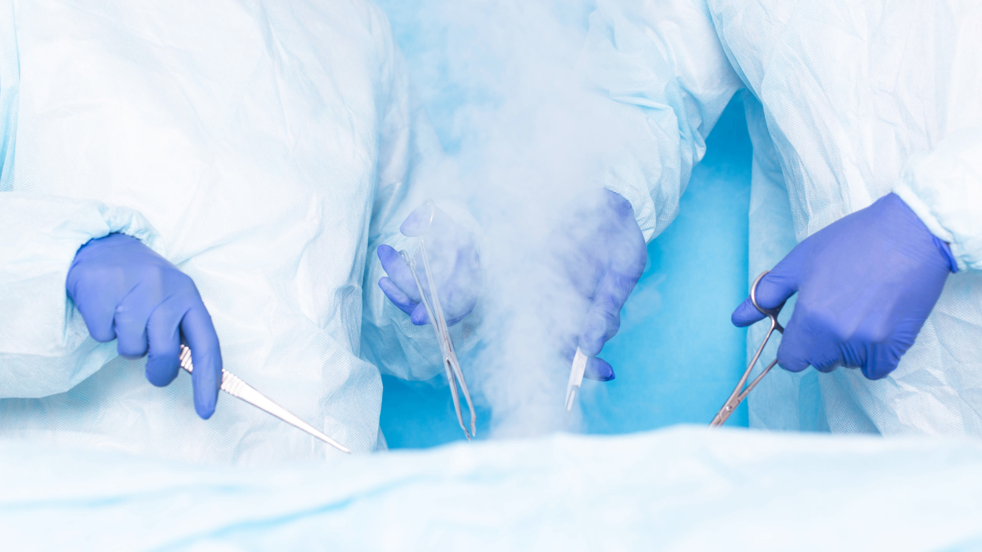 Two surgeons are operating on a patient in an operating room.