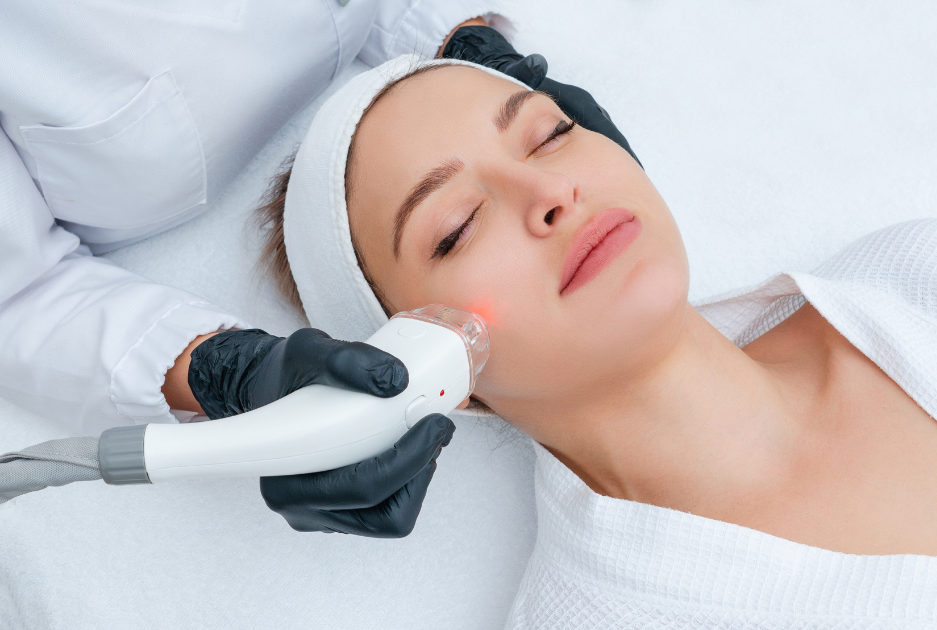 A woman is getting a laser treatment on her face.