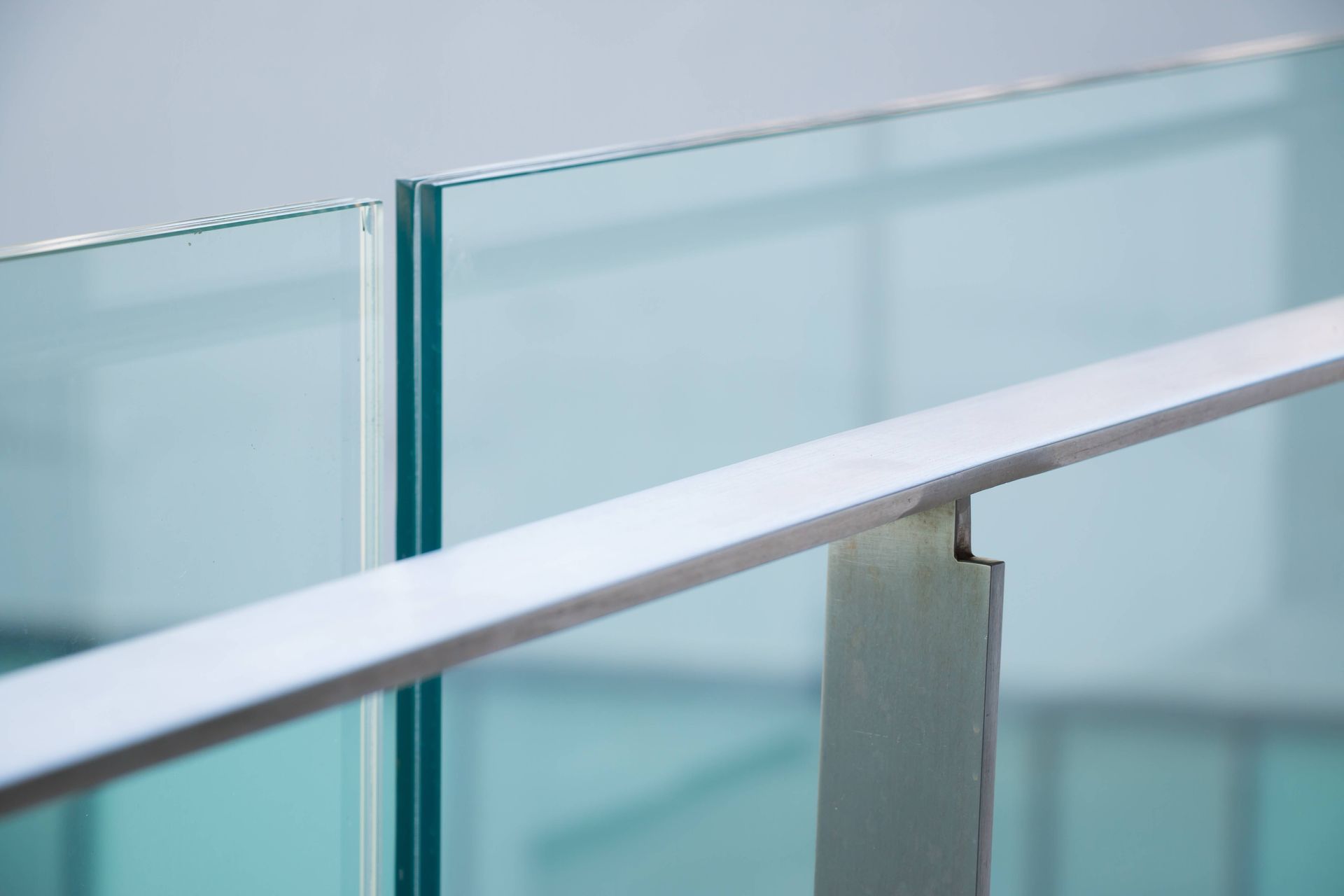 A close up of a glass railing on a staircase.