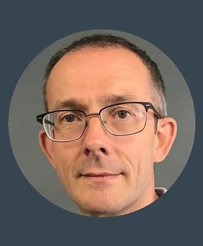 A man wearing glasses is in a circle on a blue background.