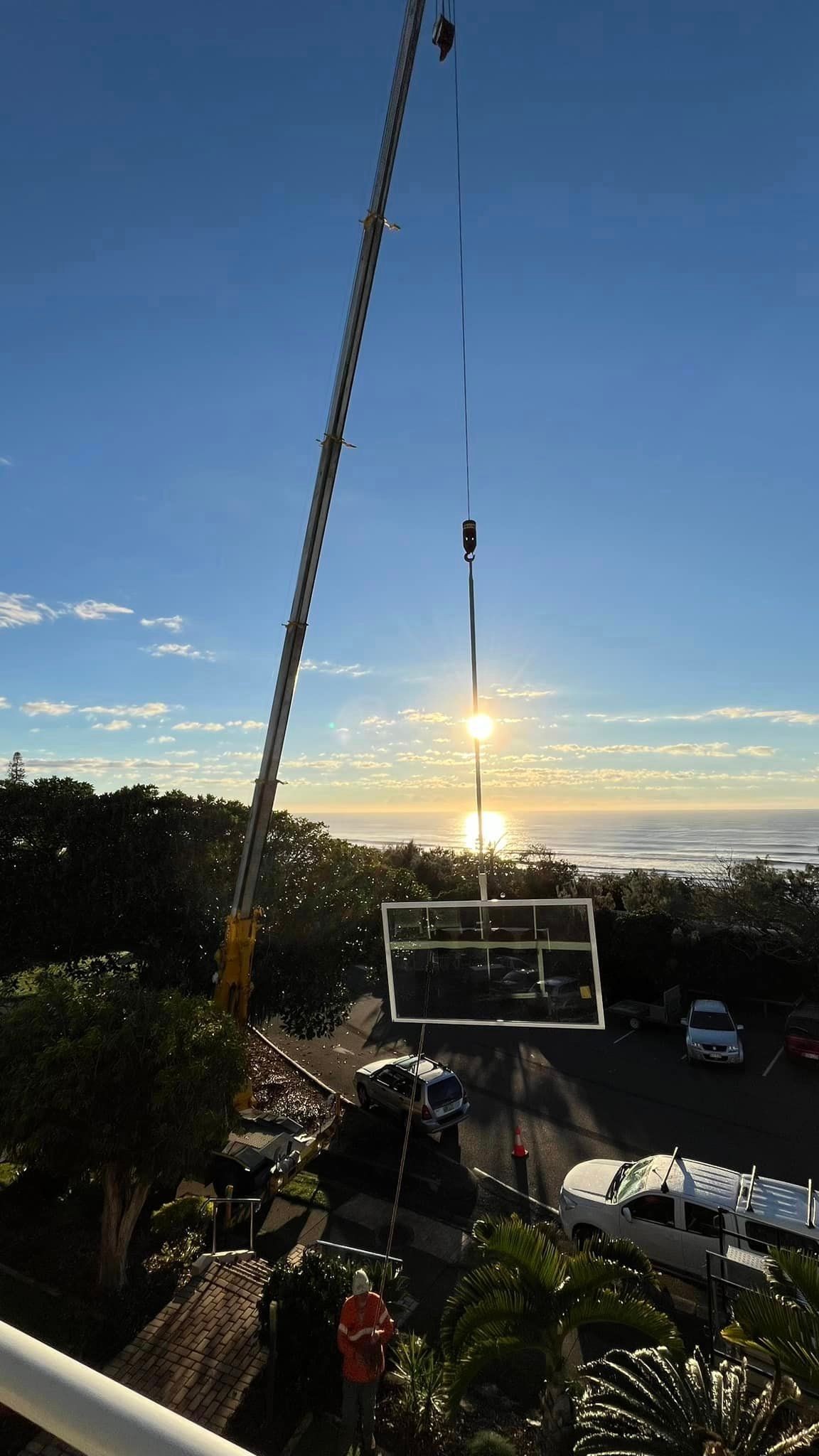 Crane Lifting A Large Glass Doors — SC Glass & Aluminium in Yandina, QLD