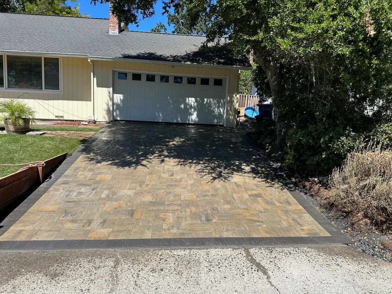 A driveway leading to a house with a white garage door.