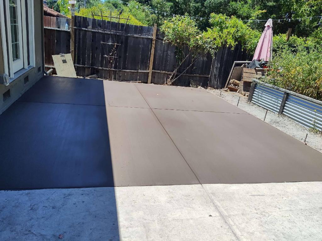 A walkway leading to a house next to a body of water.