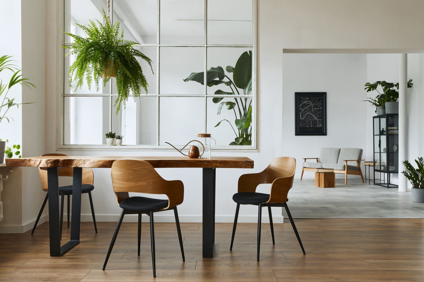 There is a table and chairs in the middle of the room.
