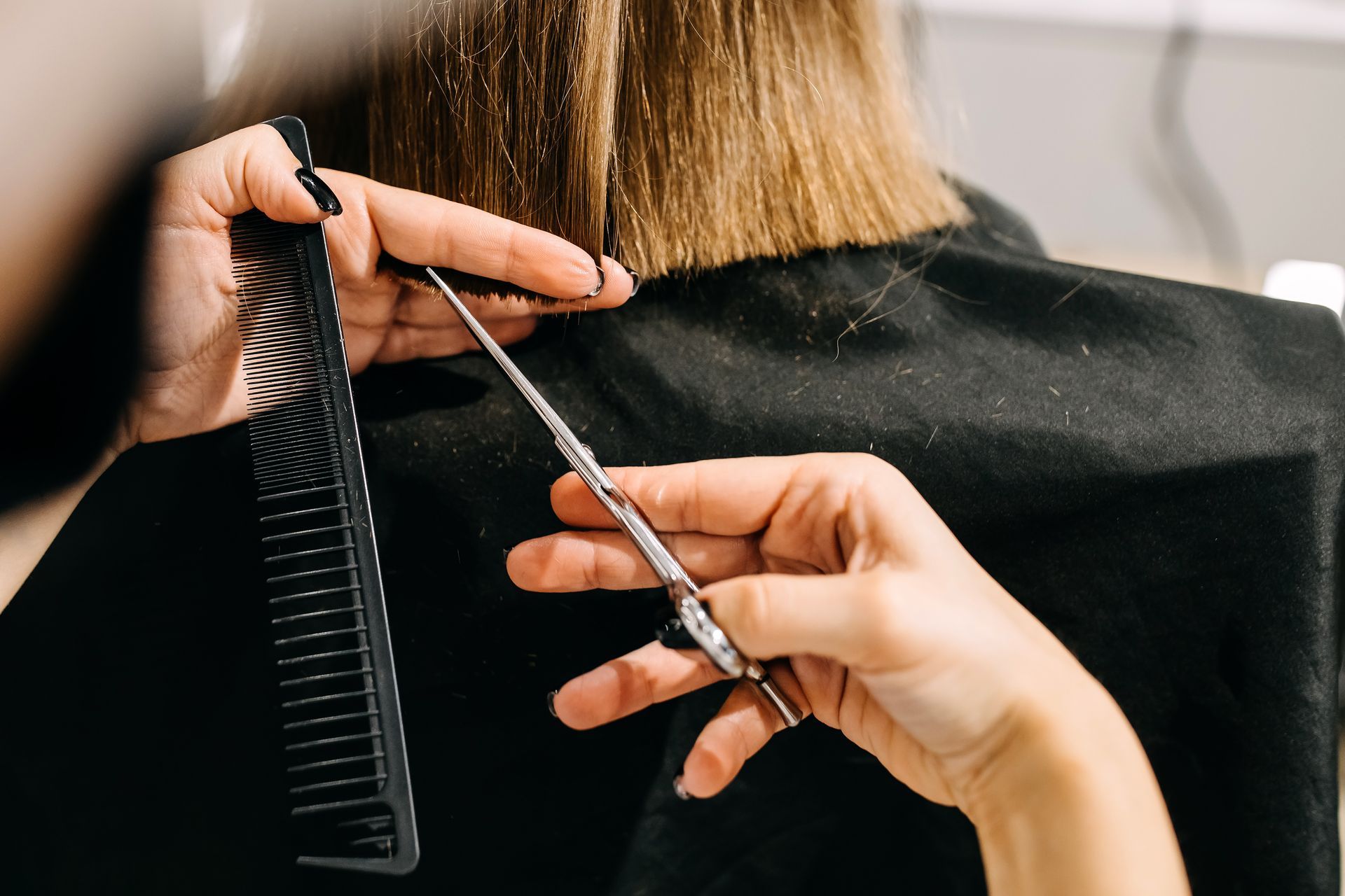Hairstylist using a round brush technique at Town Salon in Shelby Township, Michigan