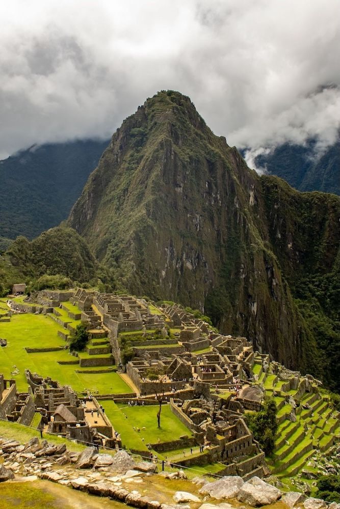 mountain in the daytime with ruins at the base