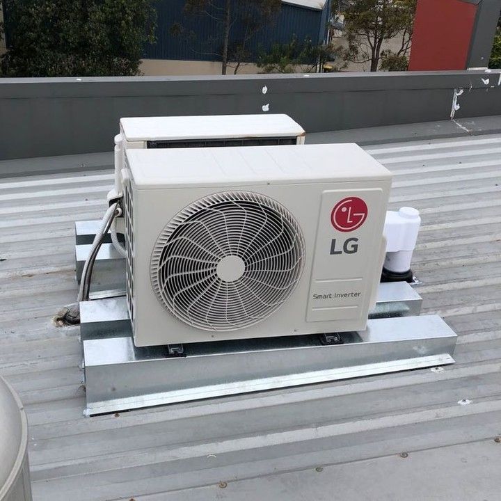 An Lg Air Conditioner is Sitting on Top of a Metal Roof — Atmosphere Air Conditioning & Refrigeration In Taylors Beach, NSW