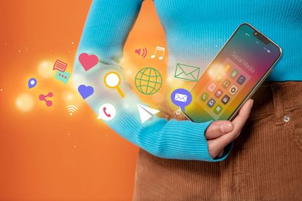 Woman holding smartphone, social media icons and glowing effects emanating from her arm.