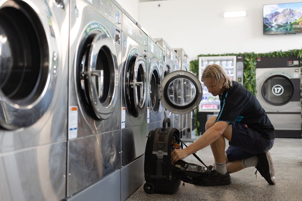 Regional Appliance & Electrical Services technician servicing commercial laundry machines.
