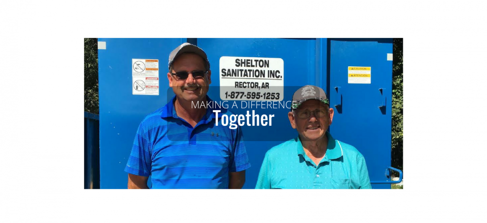 Two people stand in front of a blue door with a sign reading “Together.”