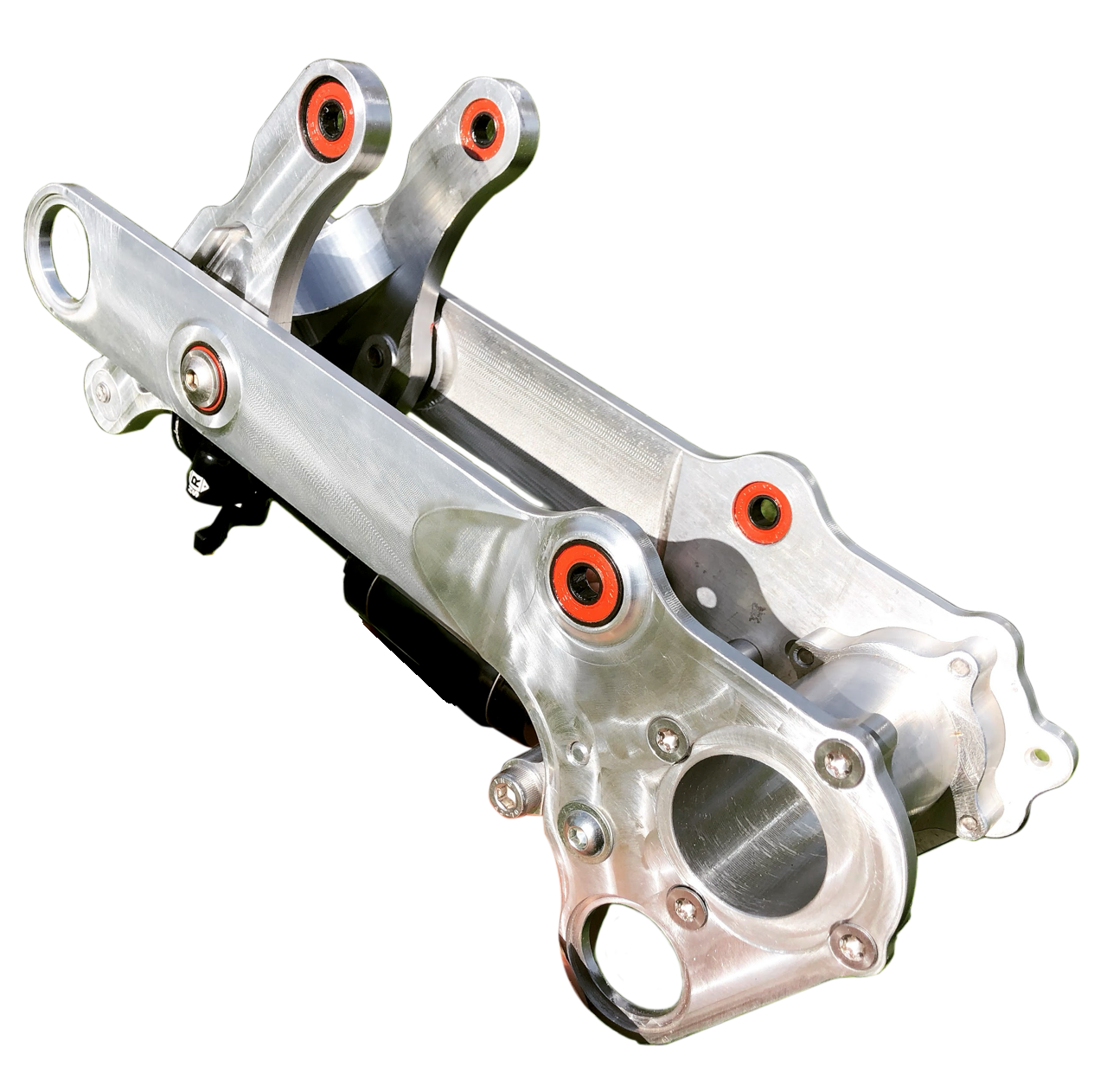 Silver motorcycle swingarm with red bushings.