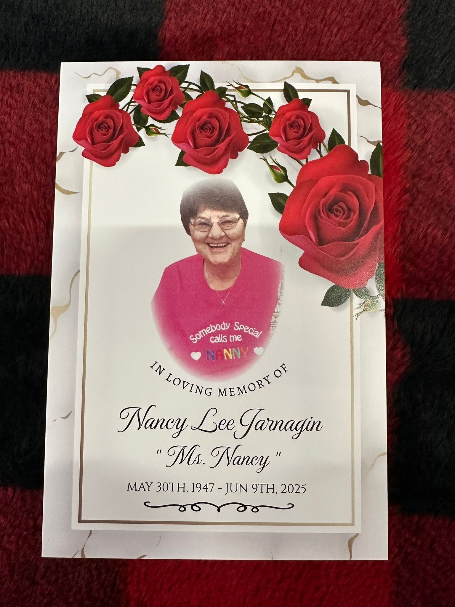 Memorial card with a photo of Nancy Lin, surrounded by roses.