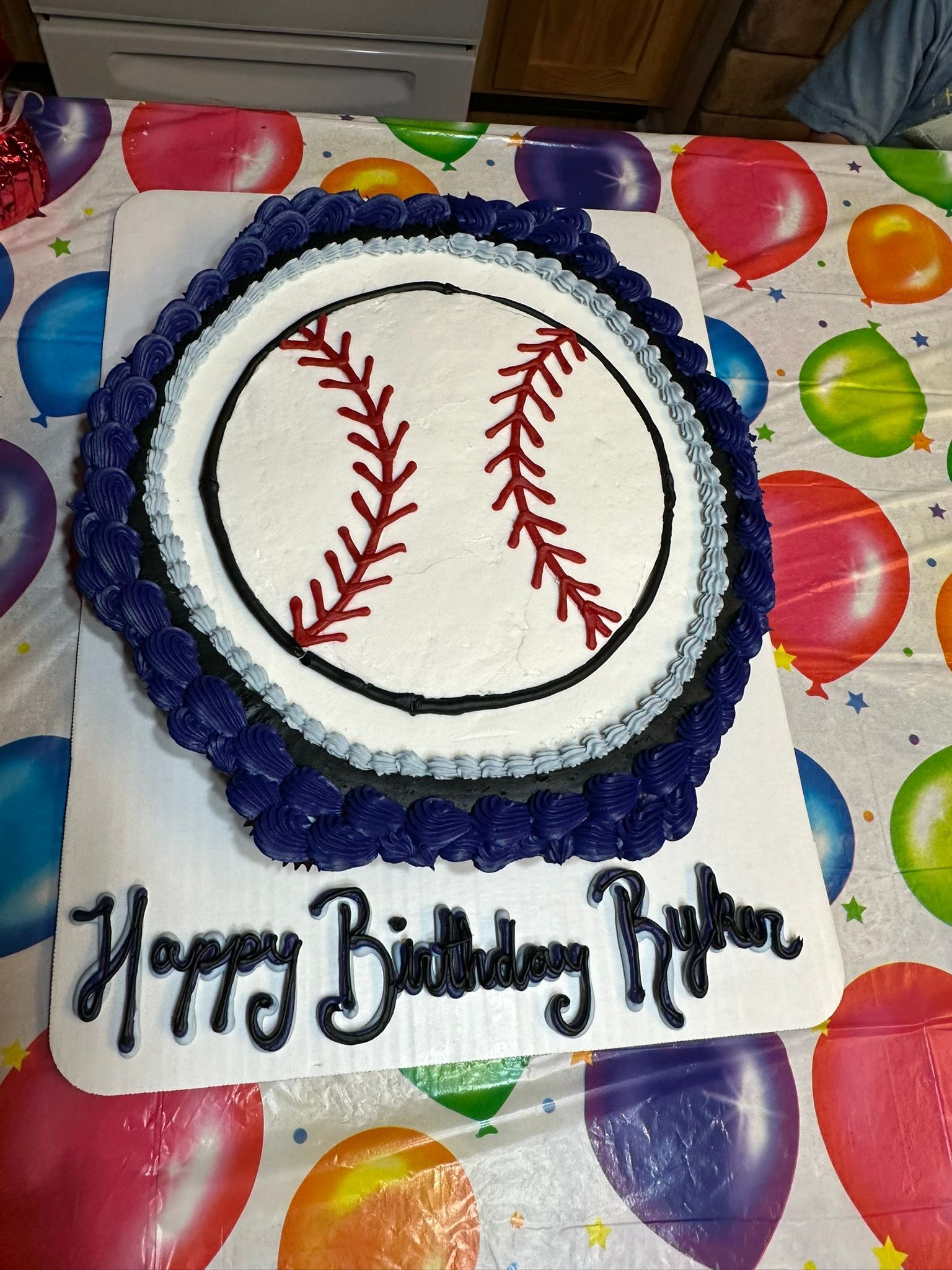 Baseball-themed birthday cake with piped frosting and 