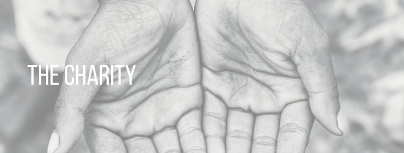 Hands cupped together with the words “THE CHARITY” overlaid on a gray background.