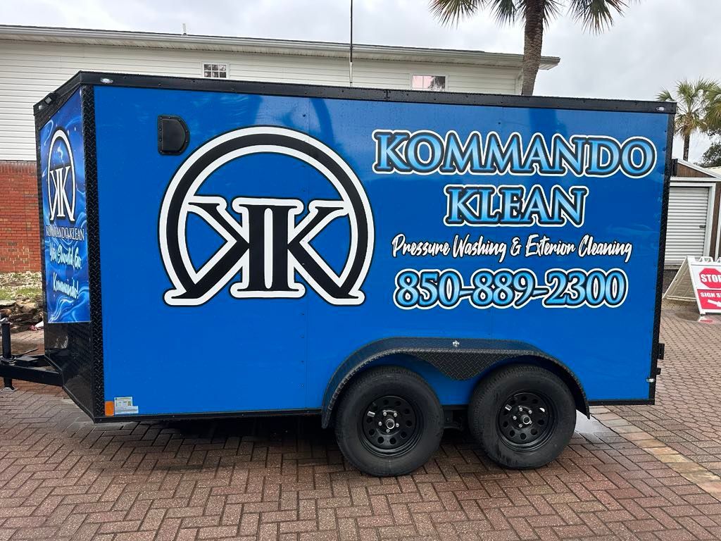 Blue Kommando Klean trailer with logo and phone number.
