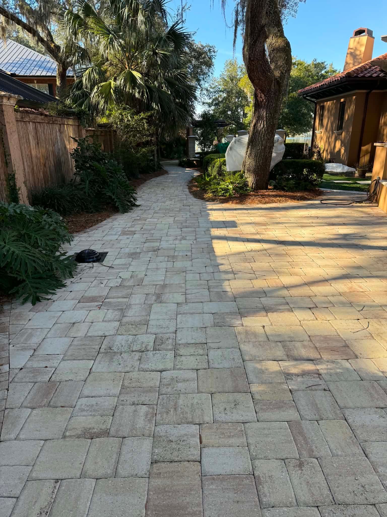 Faded residential paver courtyard before cleaning and sealing in Fort Walton Beach, FL