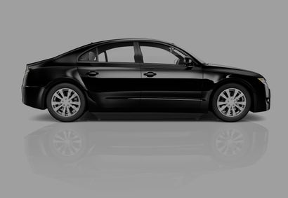 Black sedan car on a reflective surface.