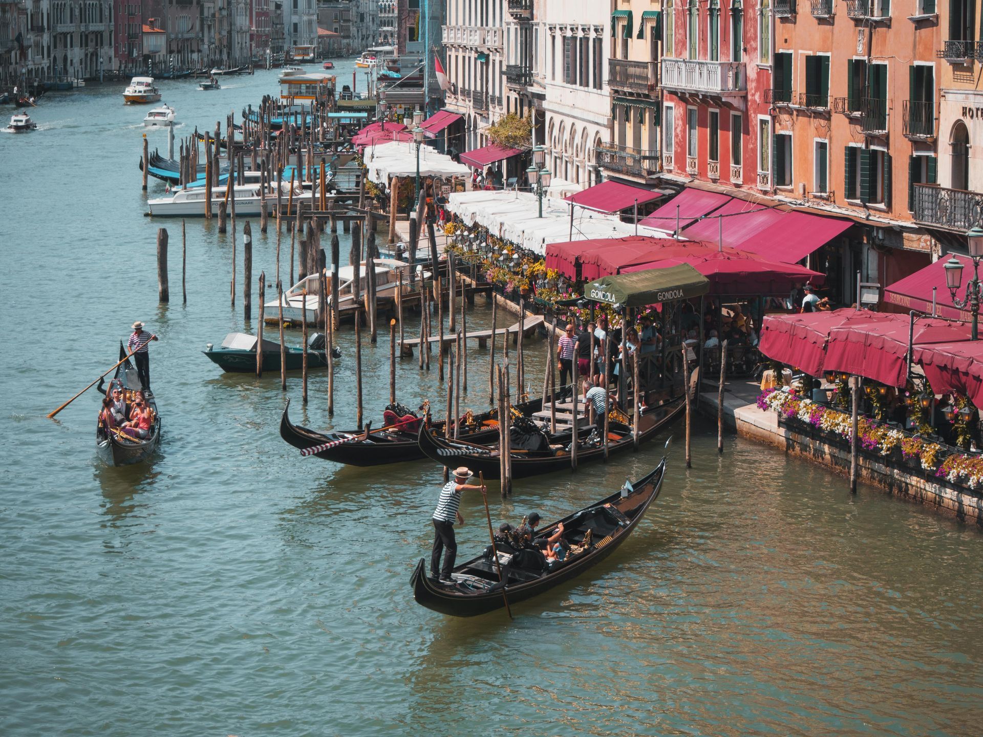 A group of people are riding a gondola down a river.