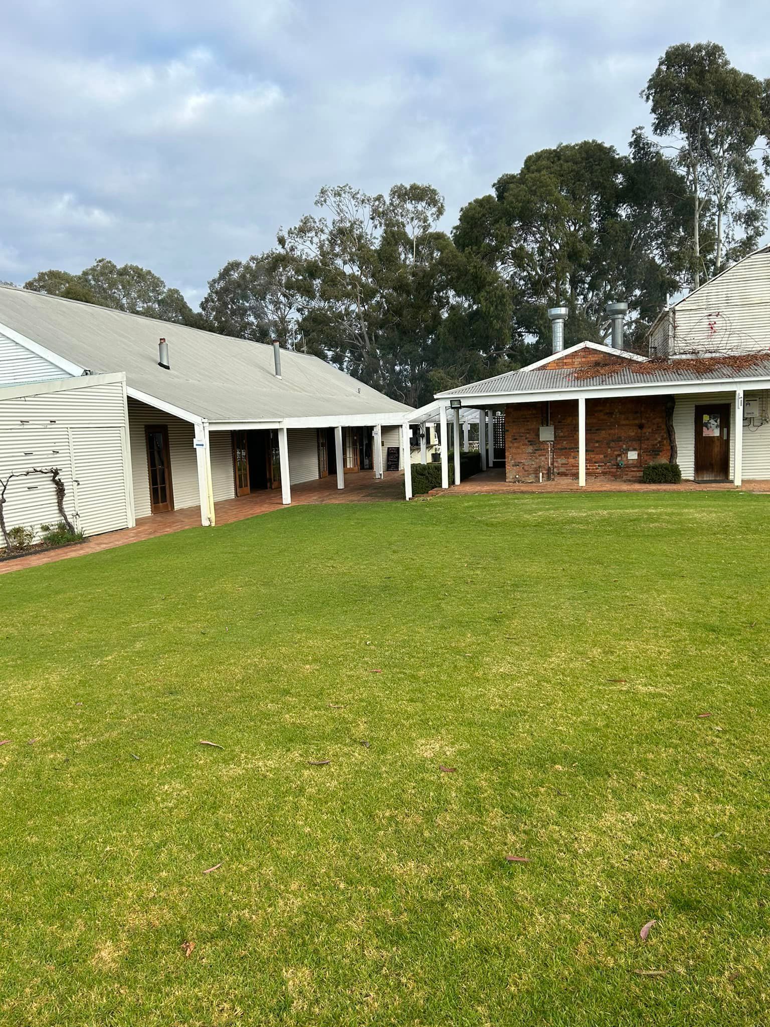 A large house with a large lawn in front of it.
