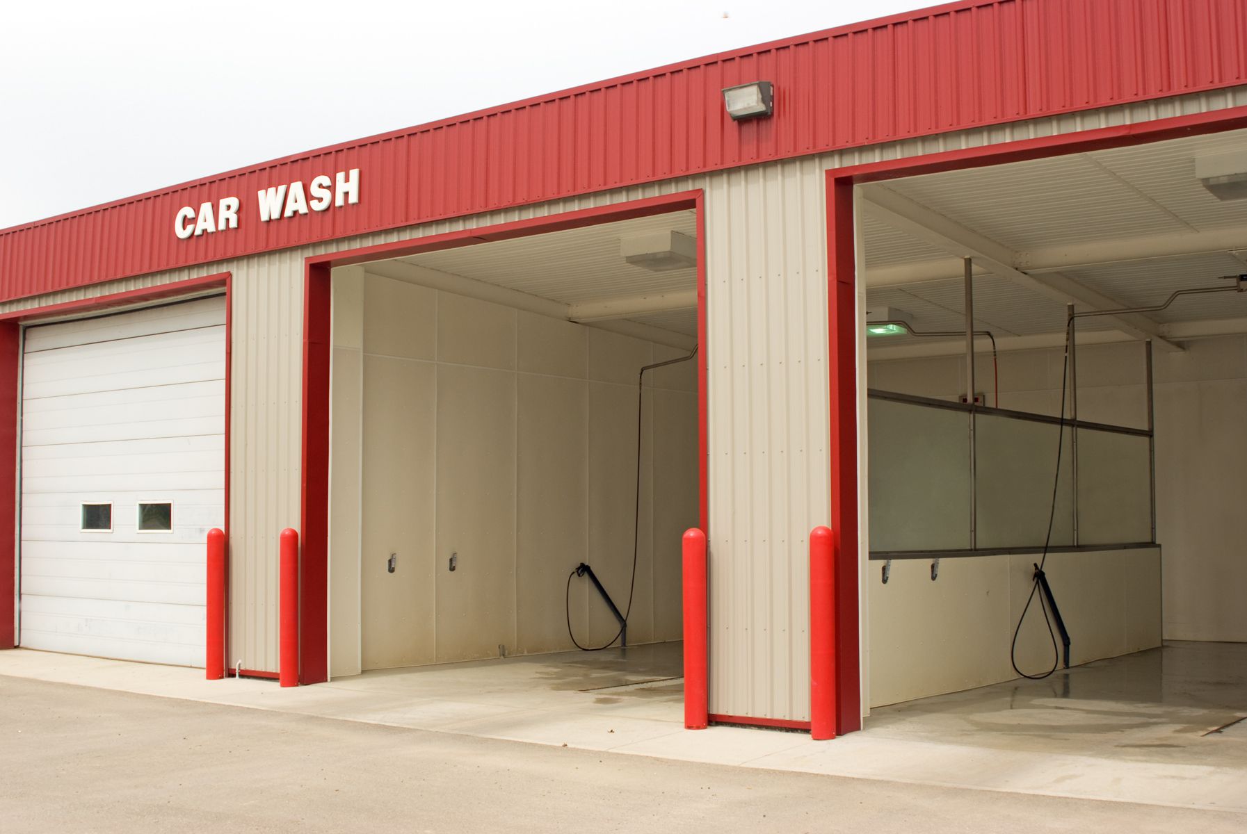 A car wash with a red roof and white doors