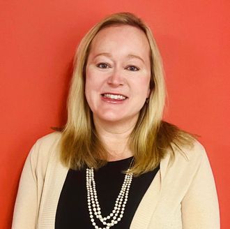Photo of woman with blonde hair on a red-orange background