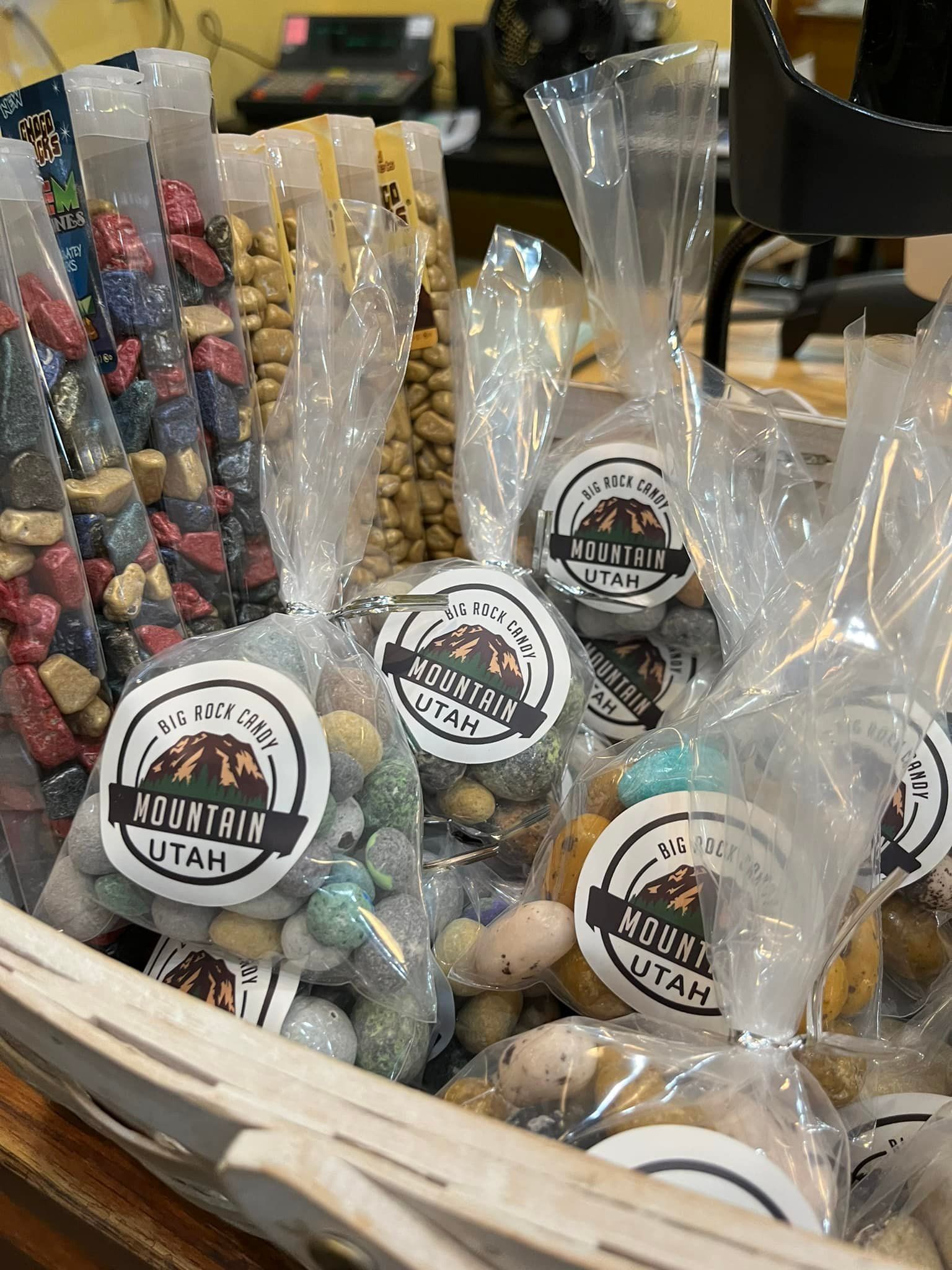 A basket filled with bags of nuts and candies.