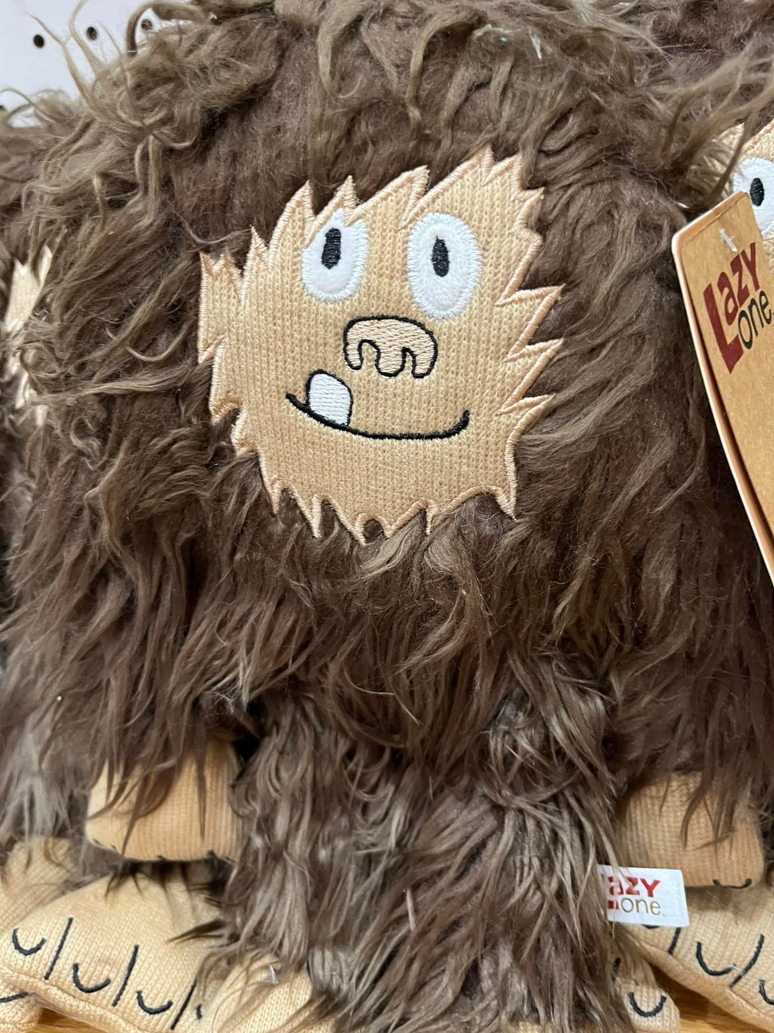 A close up of a stuffed animal with a face on it.