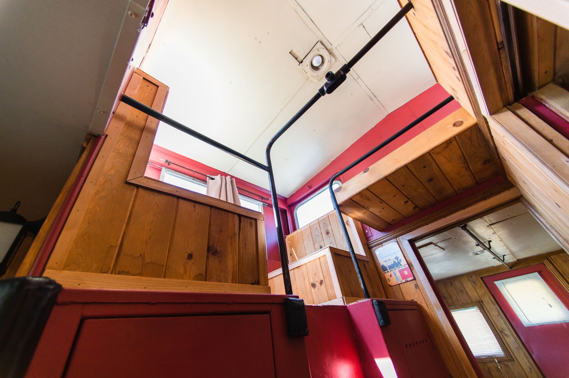 Looking up at the ceiling of a room with wooden walls
