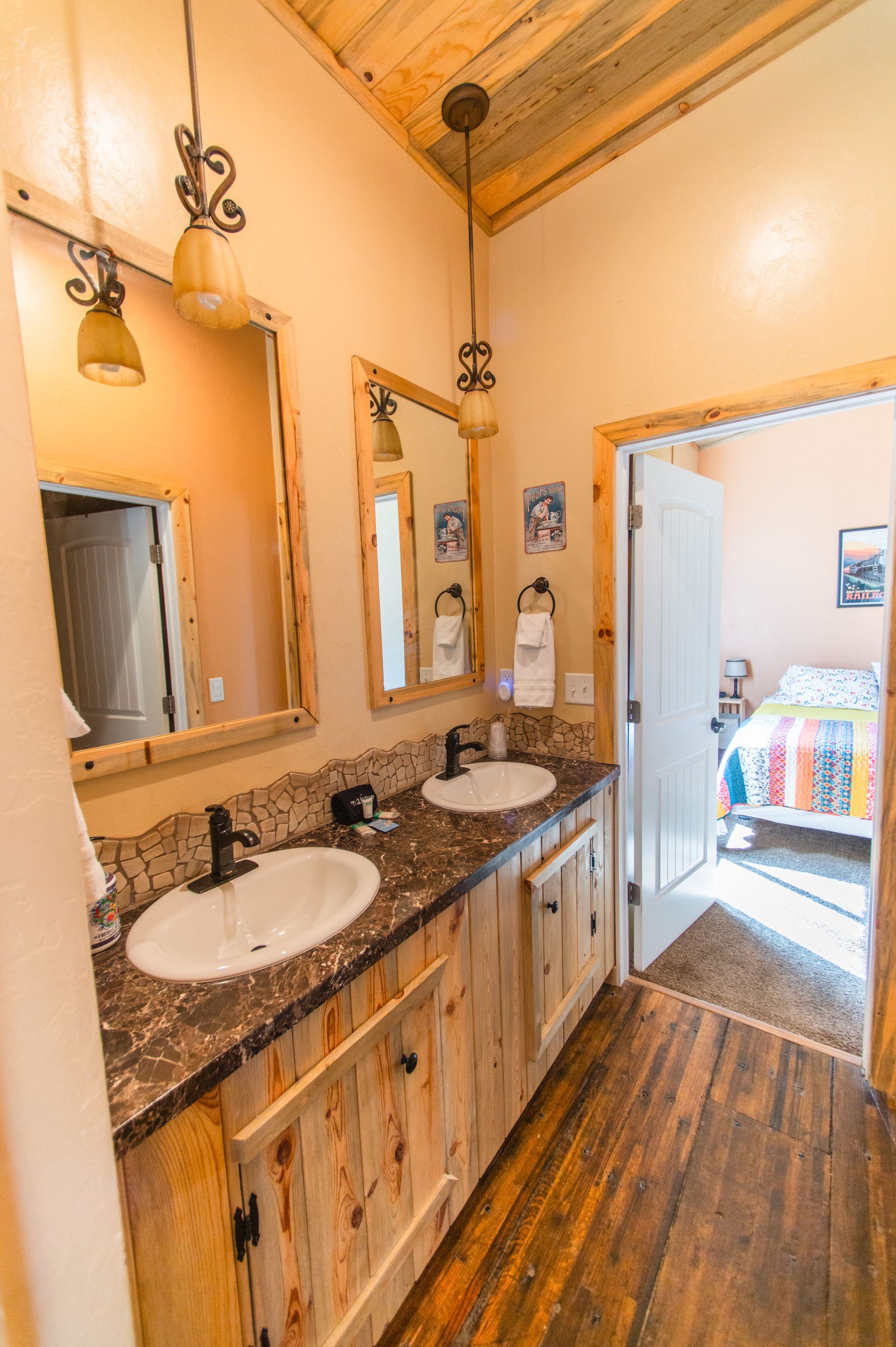 A bathroom with two sinks and two mirrors.