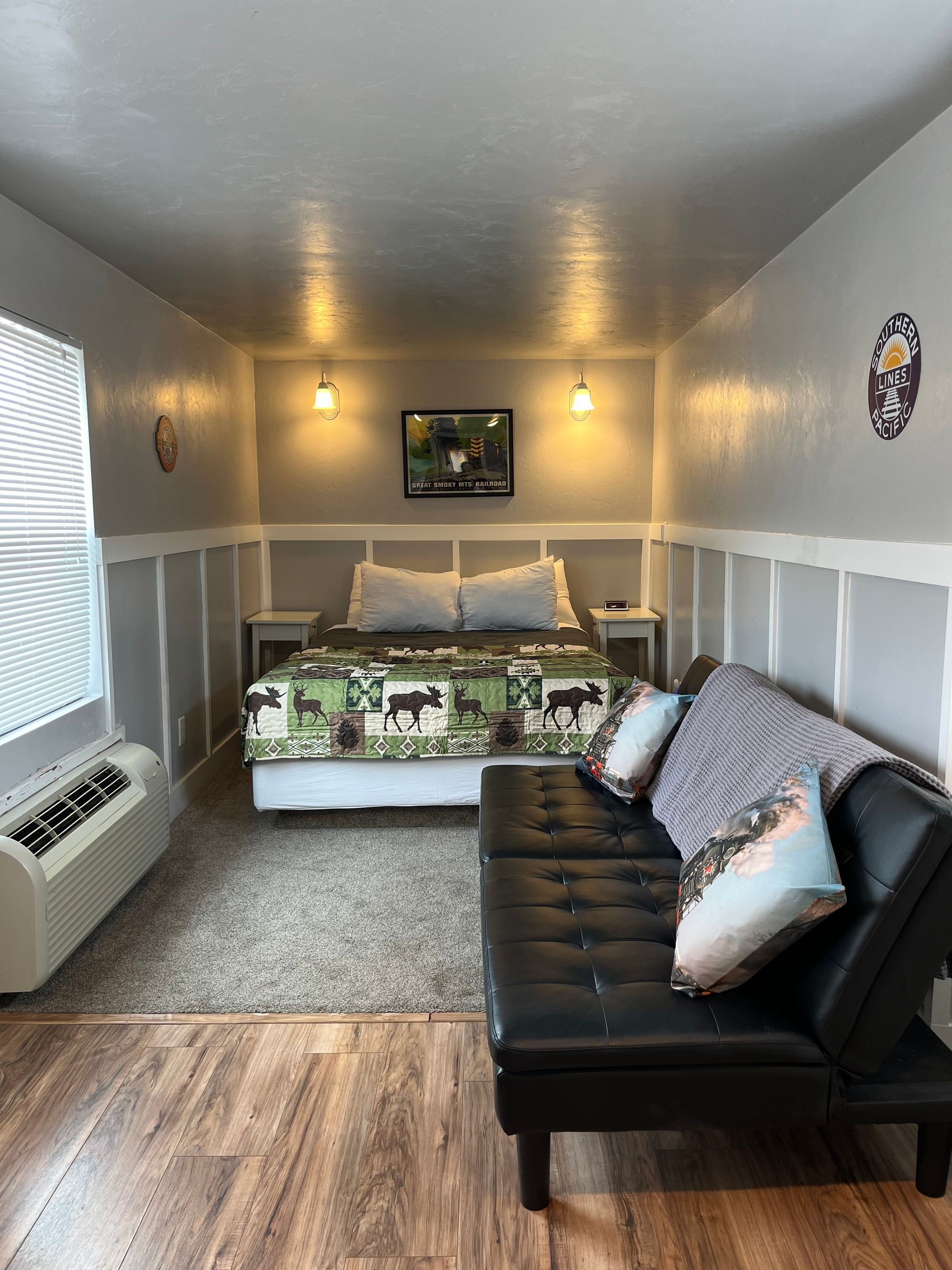 There is a bed and a couch in the room.