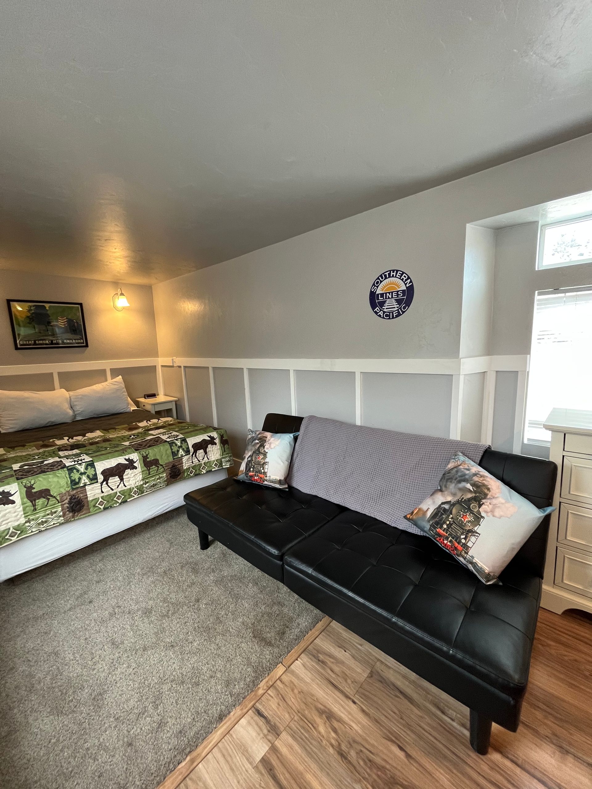 A living room with a couch and a bed in it.