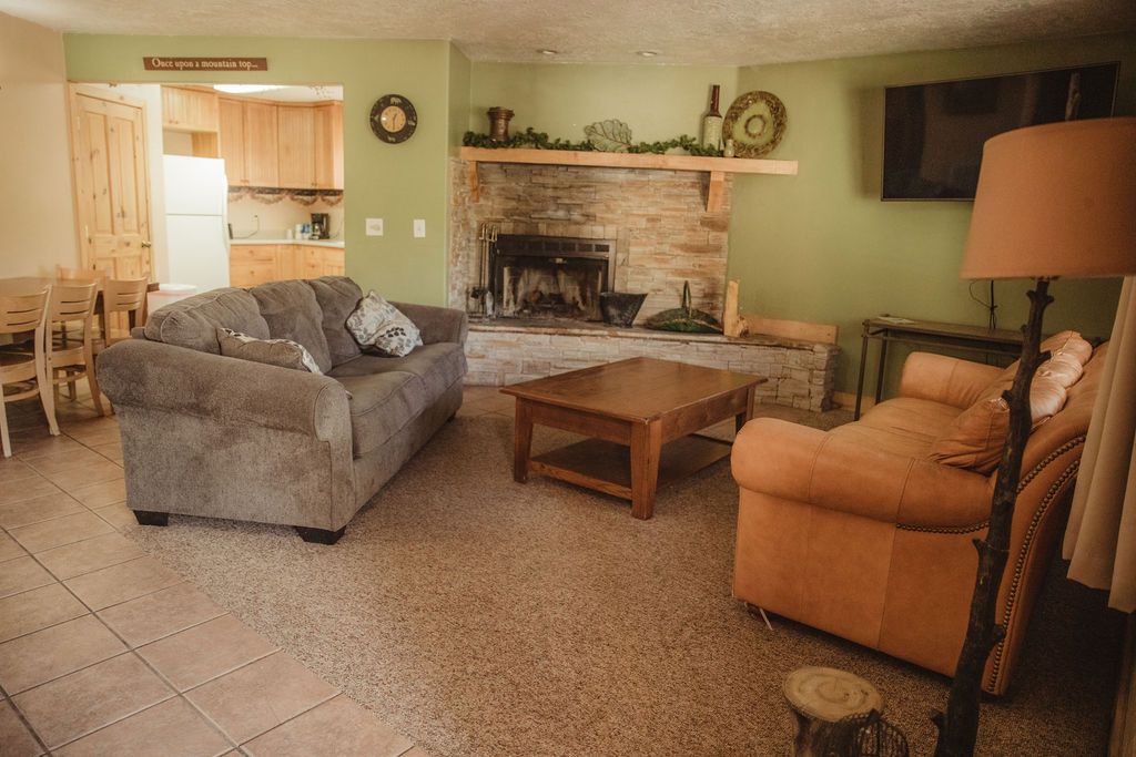 A living room filled with furniture and a fireplace.
