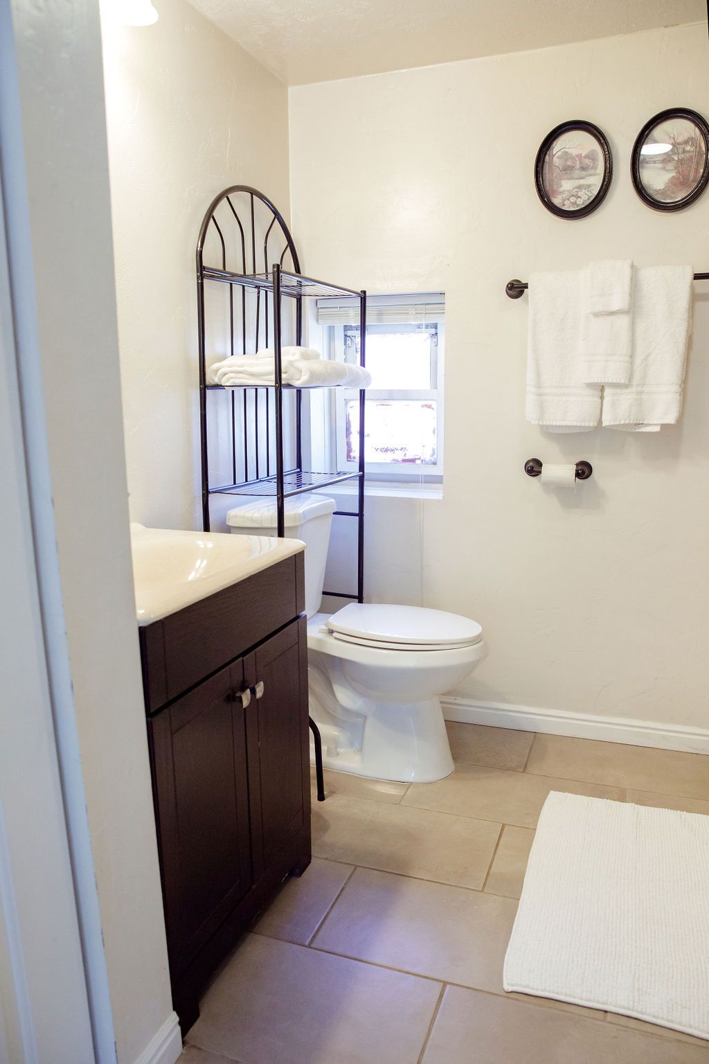 A bathroom with a toilet , sink , and mirrors.