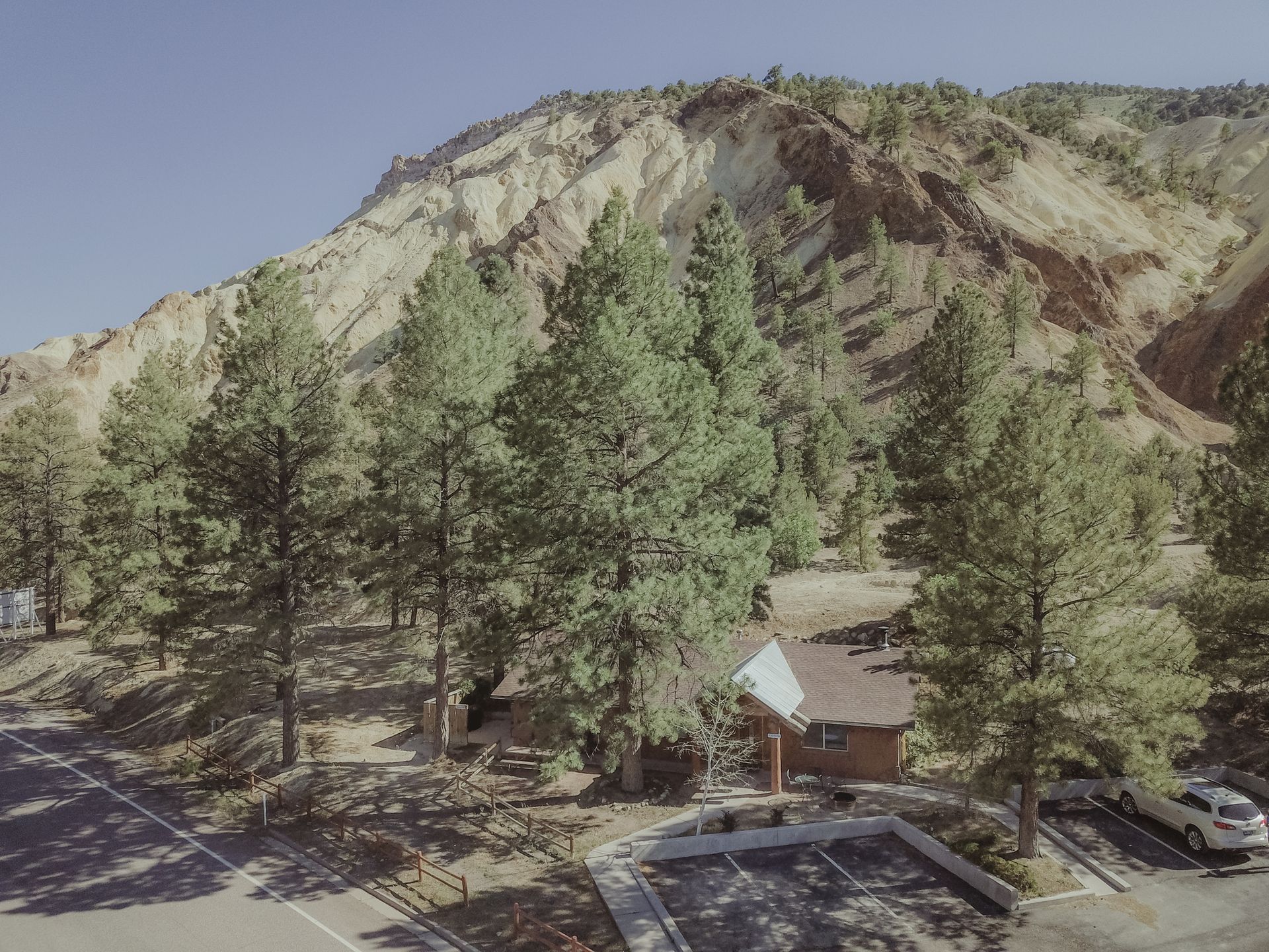 An aerial view of a parking lot in front of a mountain.