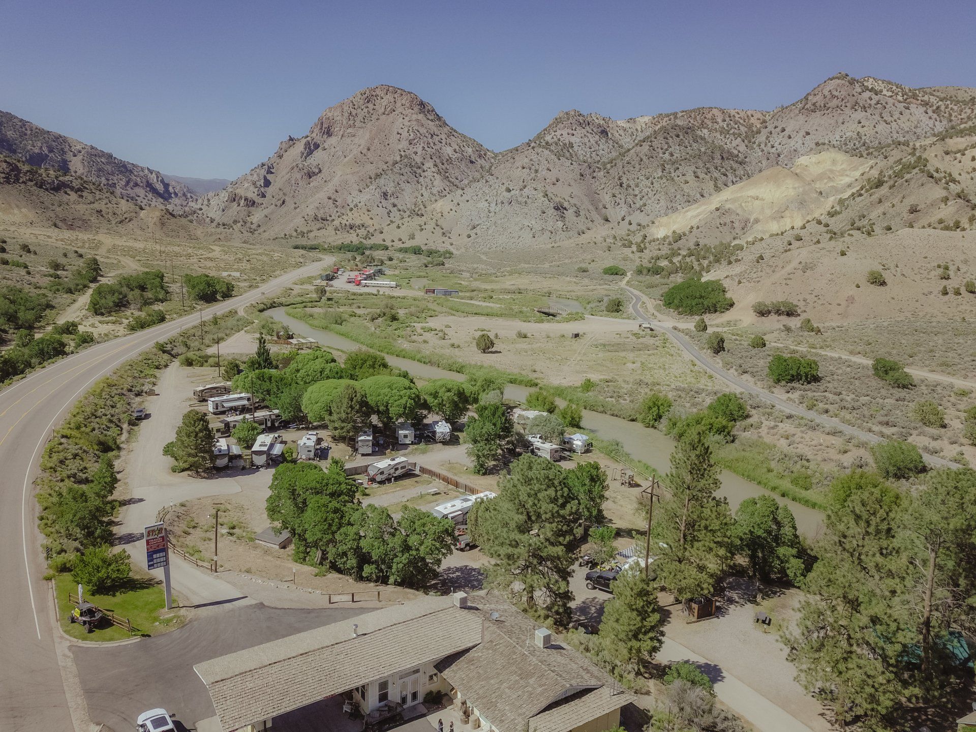 An aerial view of a campground with mountains in the background.